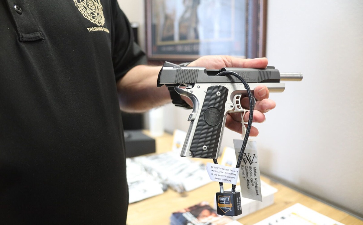 A Project ChildSafe cable lock properly installed on a Nighthawk GRP 1911 semi-automatic pistol