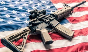 Modern Sporting Rifle on top of an American flag