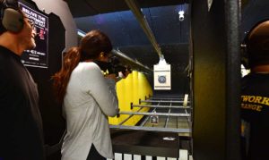 Female gun owner shooting an MSR at a gun safety class