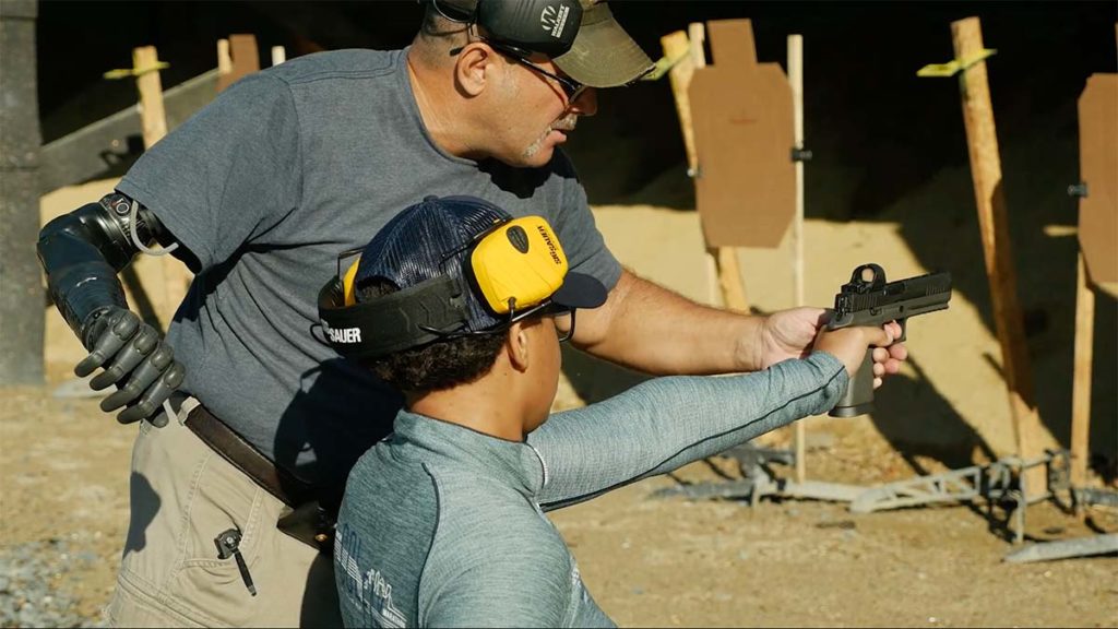 ADSS instructor Rick Cicero, himself a double amputee, helps Jataya Taylor relearn the basics as an adaptive shooter.