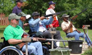 Love Freedom? Take a Vet Shooting on Veterans Day - A group of veterans at an outdoor gun range shooting shotguns at clay targets