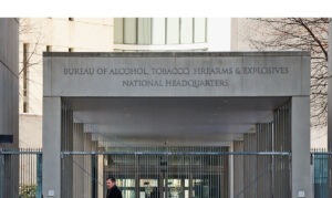 A security official walks in front of the entrance to the national headquarters of the Bureau of Alcohol, Tobacco, Firearms and Explosives (ATF) in Washington, D.C.