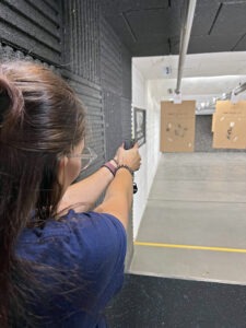 Student aiming a pistol at a target.